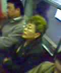 subway woman with a bright yellow-streaked mullet