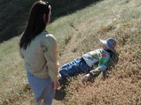 Howard lays down to feel the flowers